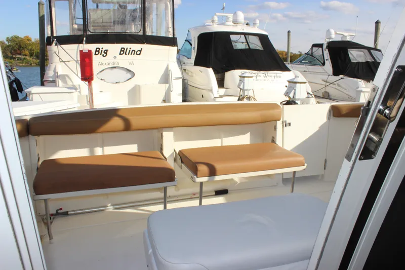 Yacht Photos Pics 2002 Regal Commodore 3880 yacht interior with tan seating and docked boats.