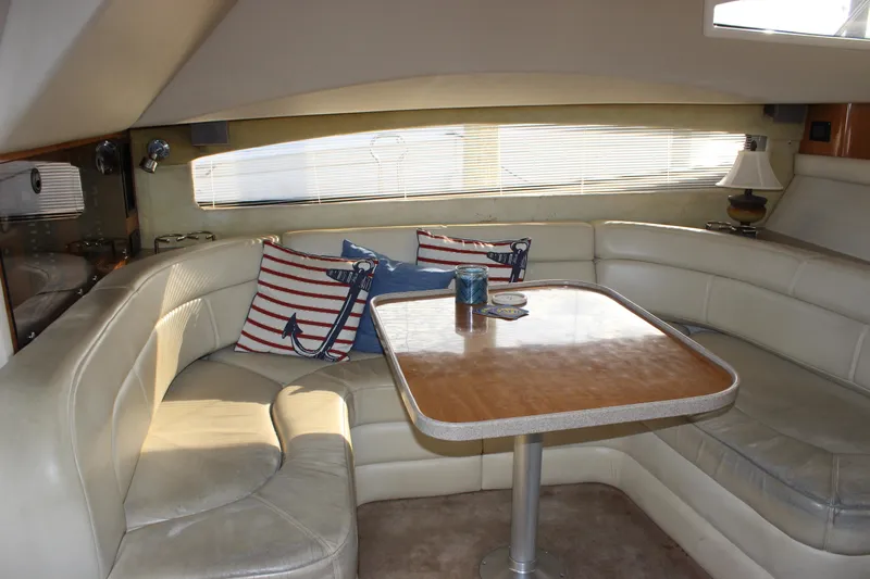  Yacht Photos Pics Interior of 2002 Regal Commodore 3880 yacht with cozy seating and nautical-themed decor.