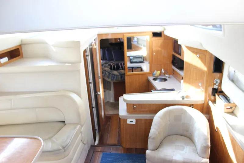  Yacht Photos Pics Interior of 2002 Regal Commodore 3880 yacht with modern furnishings and compact kitchen.