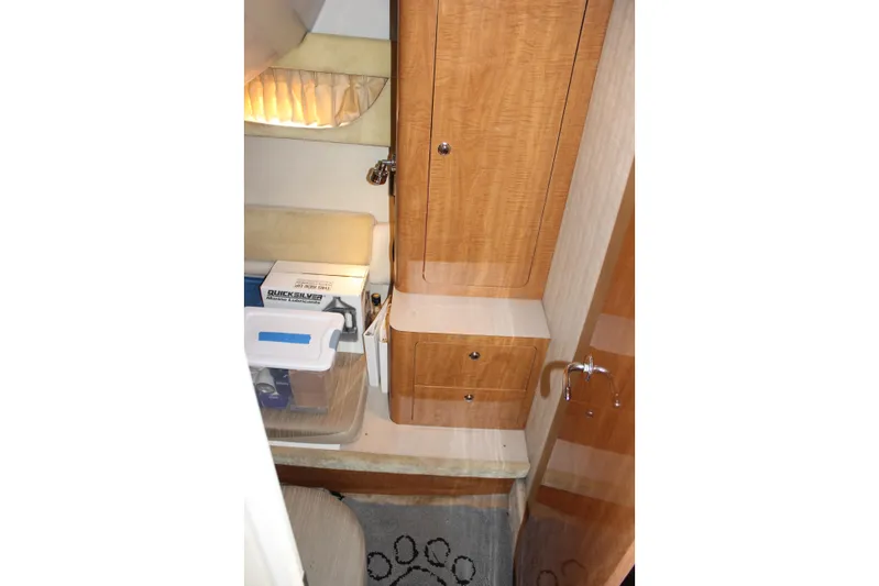  Yacht Photos Pics Interior of 2002 Regal Commodore 3880 yacht with wooden cabinets and storage area.