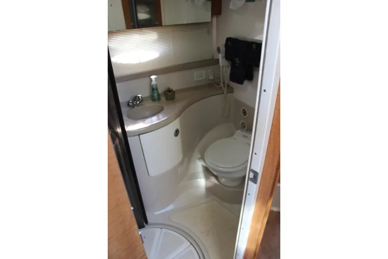  Yacht Photos Pics Bathroom interior of 2002 Regal Commodore 3880 yacht, featuring sink and toilet.