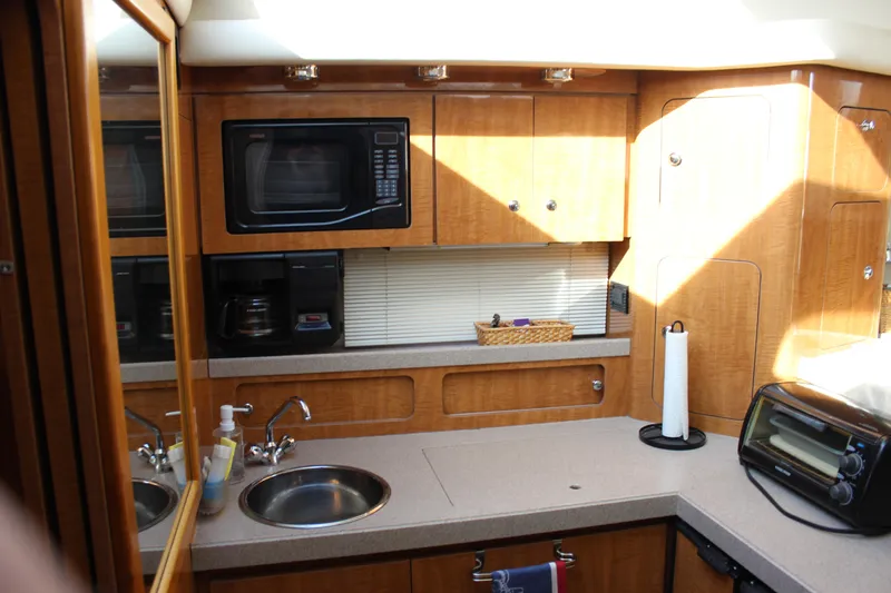  Yacht Photos Pics 2002 Regal Commodore 3880 yacht kitchen with microwave, sink, and toaster oven.