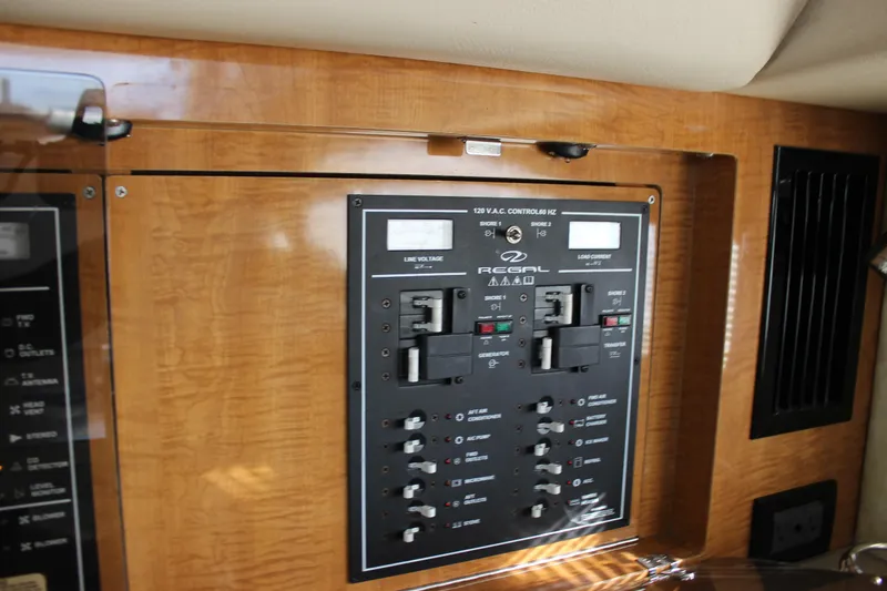  Yacht Photos Pics Control panel of a 2002 Regal Commodore 3880 boat, featuring electrical switches and indicators.