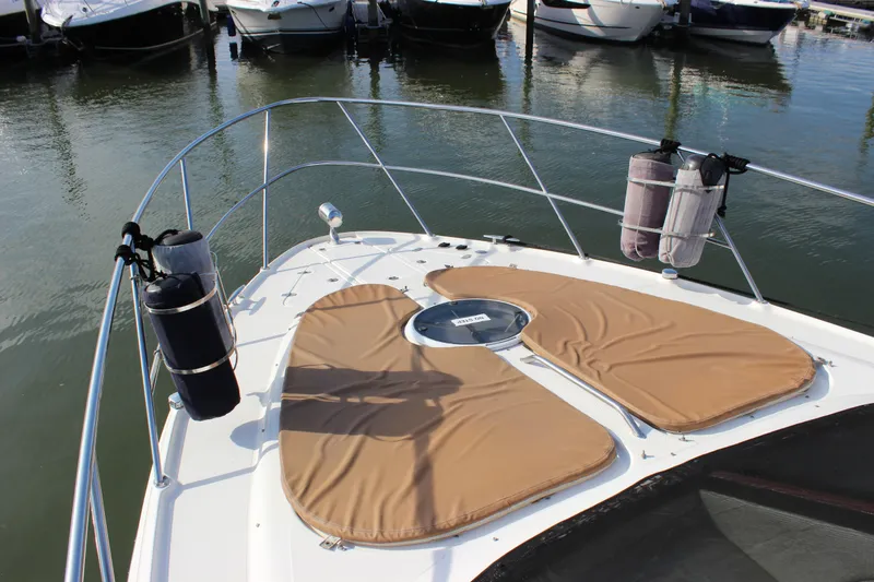  Yacht Photos Pics 2002 Regal Commodore 3880 yacht bow with tan cushions, docked in marina.
