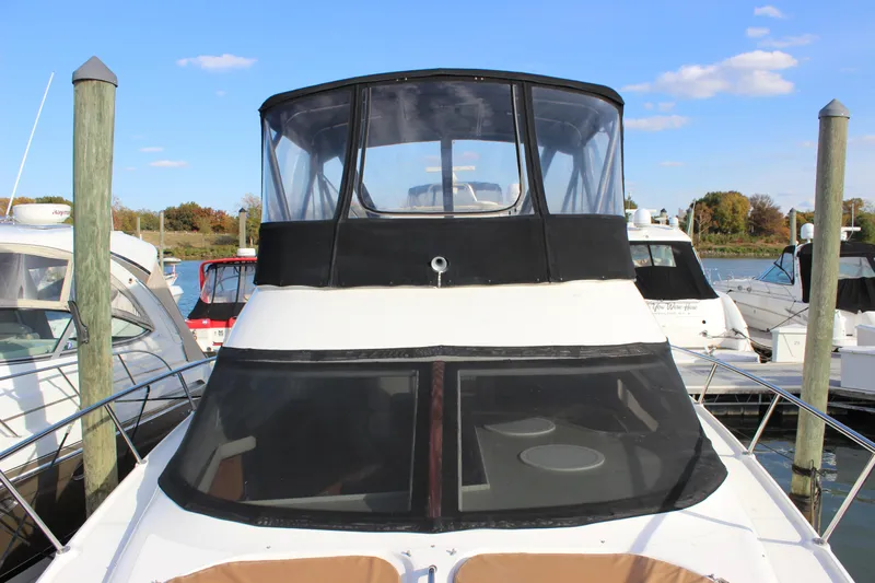  Yacht Photos Pics 2002 Regal Commodore 3880 yacht docked at marina under clear blue sky.