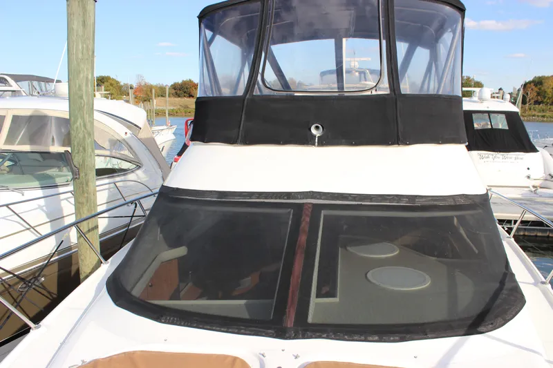  Yacht Photos Pics 2002 Regal Commodore 3880 yacht docked at marina, featuring sleek design and spacious deck.