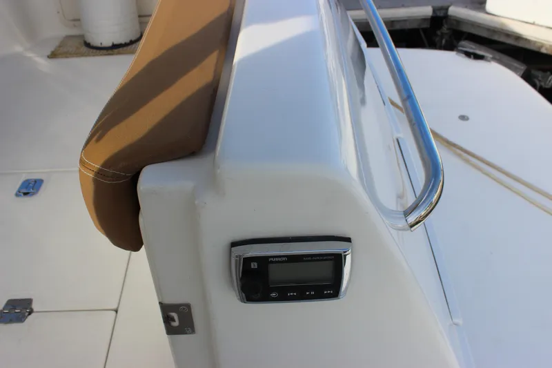  Yacht Photos Pics 2002 Regal Commodore 3880 boat deck with brown seat and control panel.