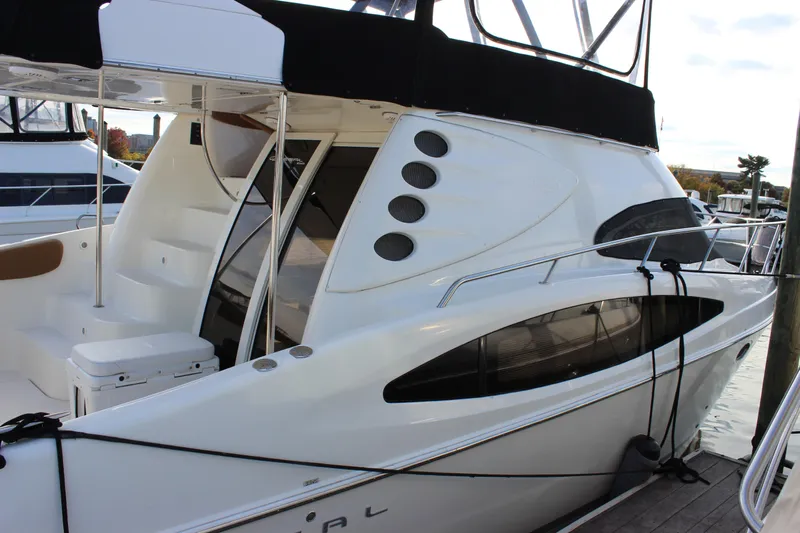  Yacht Photos Pics 2002 Regal Commodore 3880 yacht docked at marina, showcasing sleek design and modern features.