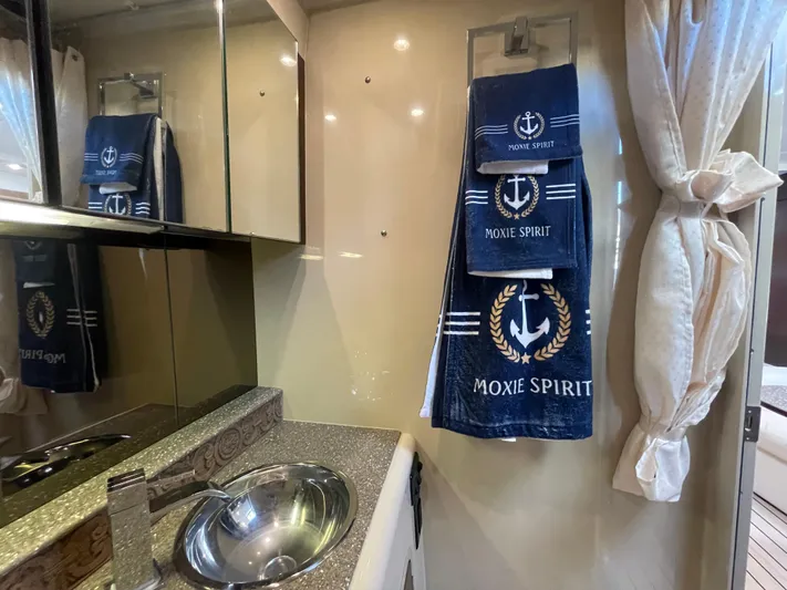 Moxie Spirit Yacht Photos Pics 2012 Cruisers Yachts 35 Express bathroom with nautical-themed towels and modern sink.