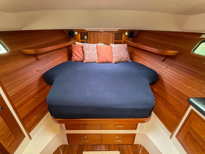 Noble Grace Yacht Photos Pics Luxurious cabin interior of 2019 MJM 43z with wooden finish and cozy bedding.