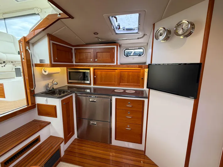 Noble Grace Yacht Photos Pics Luxurious 2019 MJM 43z yacht interior with modern kitchen and wooden cabinetry.