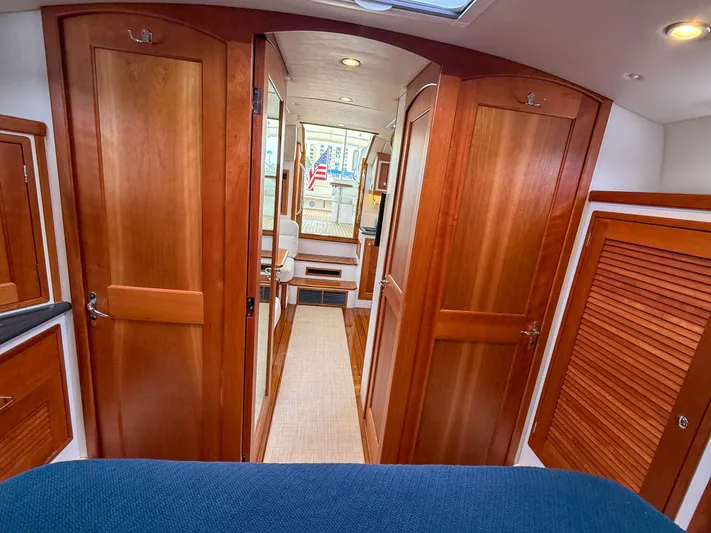 Noble Grace Yacht Photos Pics Interior of 2019 MJM 43z yacht with wooden cabinetry and blue upholstery.