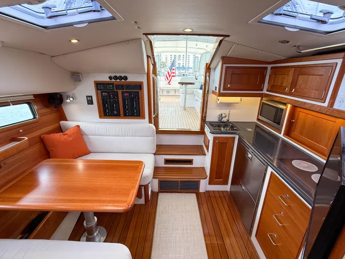 Noble Grace Yacht Photos Pics Luxurious interior of a 2019 MJM 43z yacht with wood finishes and modern amenities.