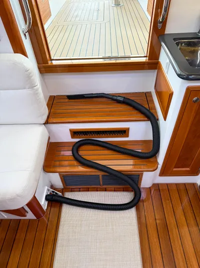 Noble Grace Yacht Photos Pics Interior of 2019 MJM 43z yacht with wooden steps and coiled black hose.