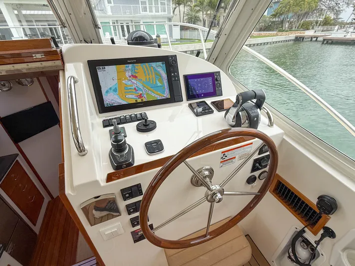 Noble Grace Yacht Photos Pics Helm of 2019 MJM 43z boat with navigation screens and wooden steering wheel.