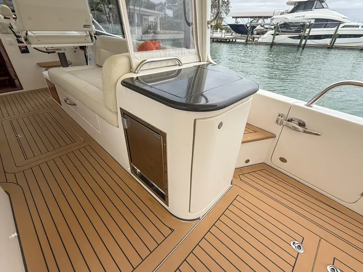 Noble Grace Yacht Photos Pics 2019 MJM 43z yacht deck with teak flooring and seating area by the water.