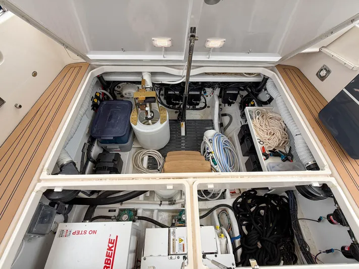 Noble Grace Yacht Photos Pics Engine compartment of a 2019 MJM 43z boat, showcasing organized equipment and storage.