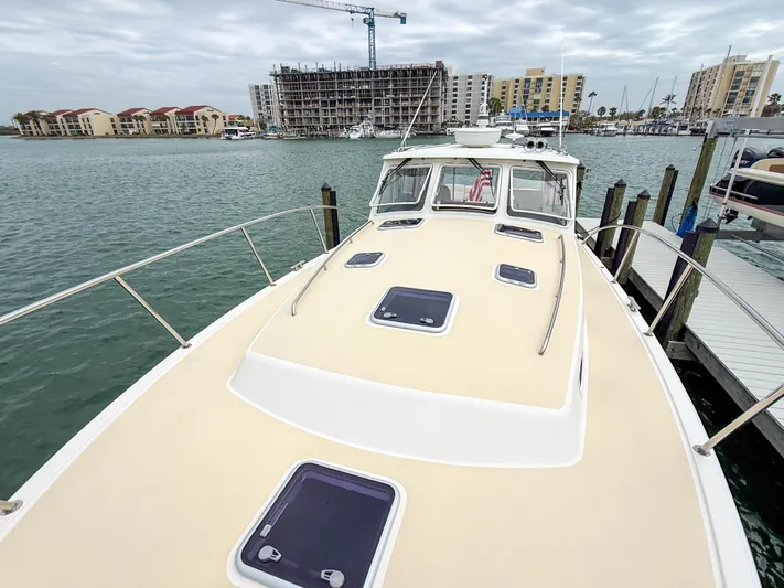 Noble Grace Yacht Photos Pics 2019 MJM 43z boat docked at marina with cityscape background.