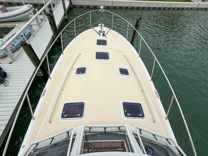 Noble Grace Yacht Photos Pics 2019 MJM 43z boat deck view at marina, featuring multiple hatches and railings.