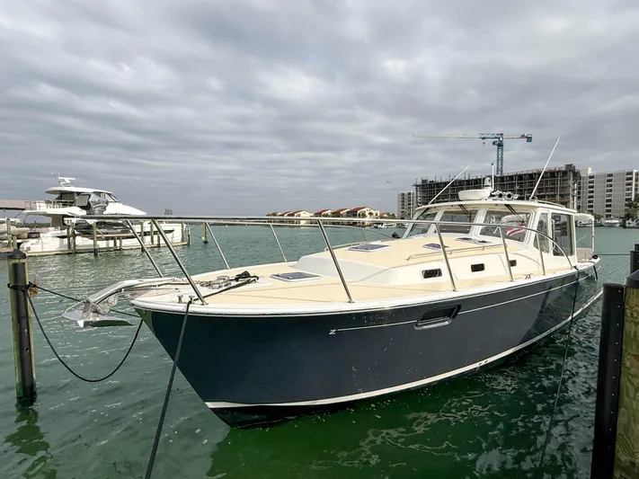 Noble Grace Yacht Photos Pics 2019 MJM 43z boat docked in a marina with cloudy skies.