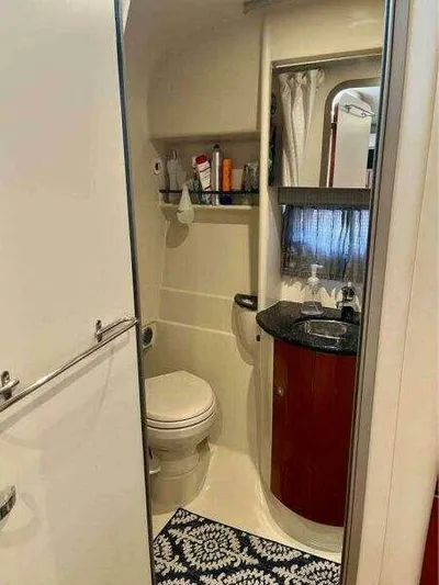 Attitude Is Everything Yacht Photos Pics 2007 Formula 31 PC bathroom with toilet, sink, and storage shelves.