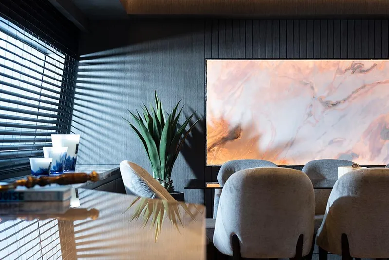  Yacht Photos Pics Luxurious yacht interior with modern decor, featuring elegant seating and a large marble artwork.