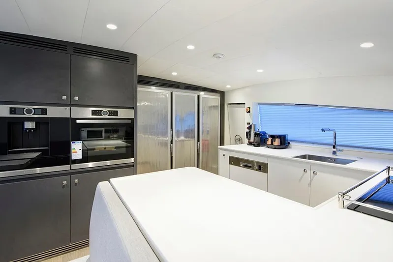  Yacht Photos Pics Modern kitchen interior on 1988 Heesen 32 yacht, featuring sleek appliances and minimalist design.