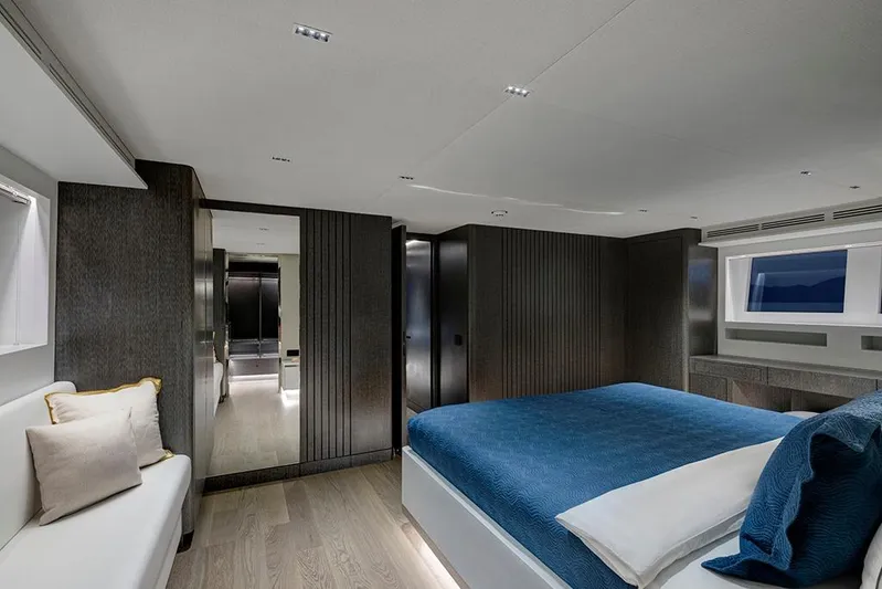  Yacht Photos Pics Luxurious bedroom interior of 1988 Heesen 32 yacht with modern design and blue bedding.