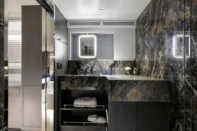  Yacht Photos Pics Luxurious yacht bathroom with marble surfaces, modern fixtures, and elegant lighting on a 1988 Heesen 32.