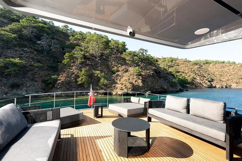  Yacht Photos Pics Luxurious deck of 1988 Heesen 32 yacht with scenic coastal view.