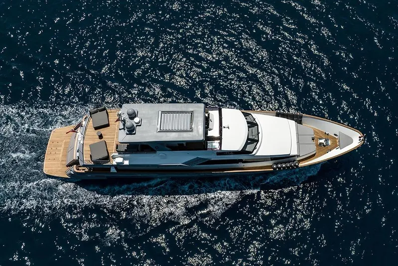  Yacht Photos Pics Aerial view of 1988 Heesen 32 yacht cruising on sparkling blue water.