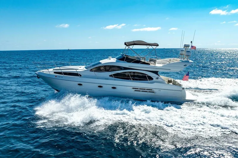  Yacht Photos Pics 2001 Azimut 46 yacht cruising on open sea under clear blue sky.