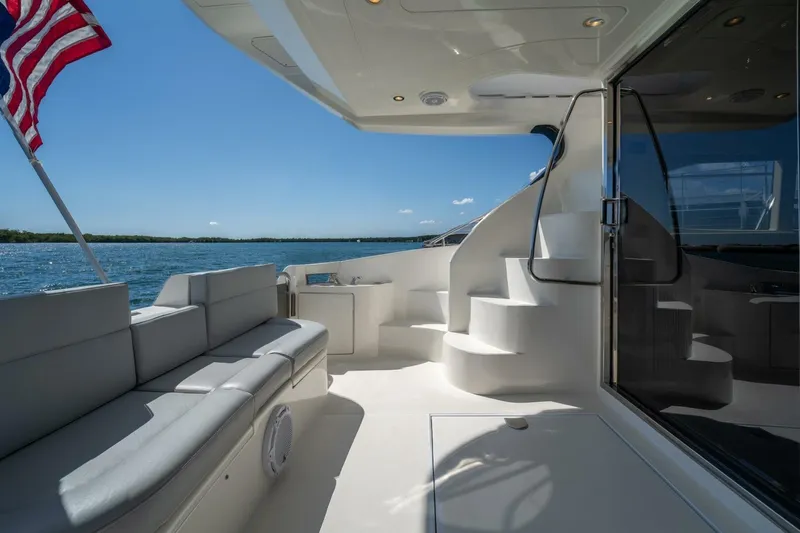  Yacht Photos Pics Luxurious 2001 Azimut 46 yacht deck with seating, stairs, and American flag.