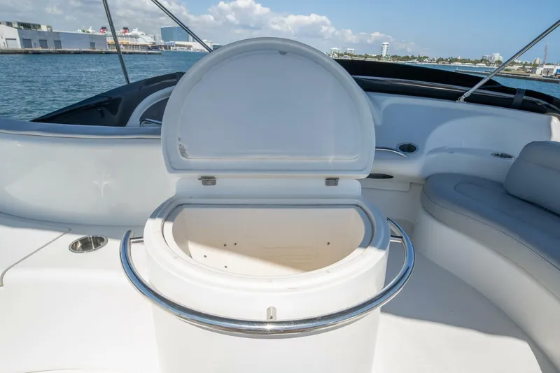  Yacht Photos Pics Open storage compartment on 2001 Azimut 46 yacht deck, with ocean and cityscape background.