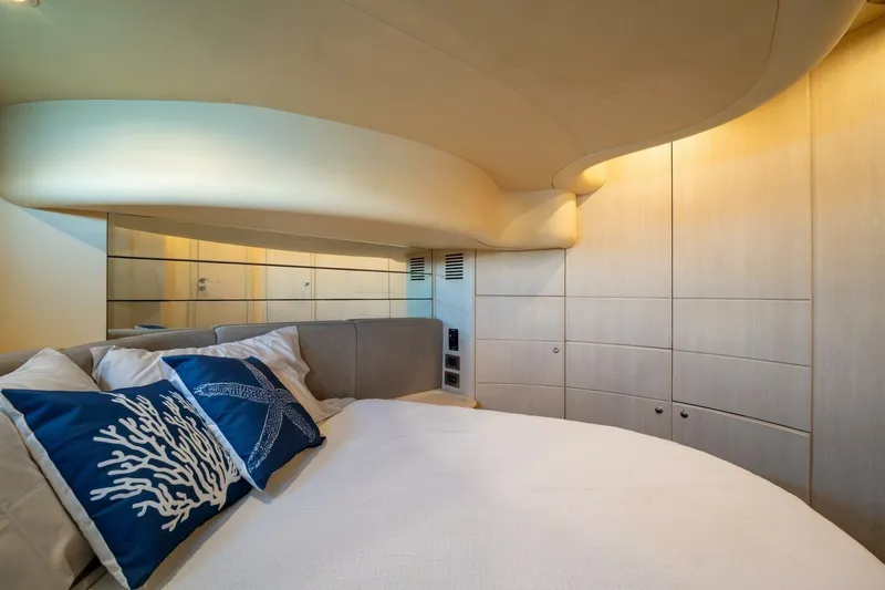  Yacht Photos Pics Luxurious bedroom interior of 2001 Azimut 46 yacht with elegant decor and blue pillows.