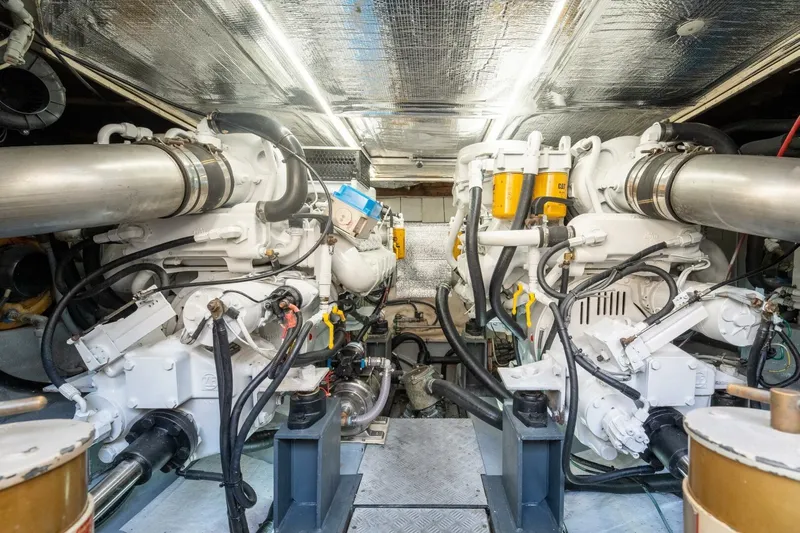  Yacht Photos Pics Engine room of a 2001 Azimut 46 yacht, featuring dual engines and complex piping.