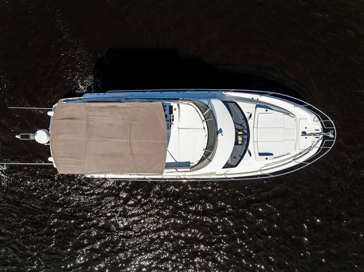  Yacht Photos Pics Aerial view of 2018 Prestige 460 yacht cruising on dark water.