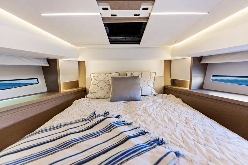  Yacht Photos Pics Luxurious bedroom interior of 2018 Prestige 460 yacht with cozy bedding and modern lighting.