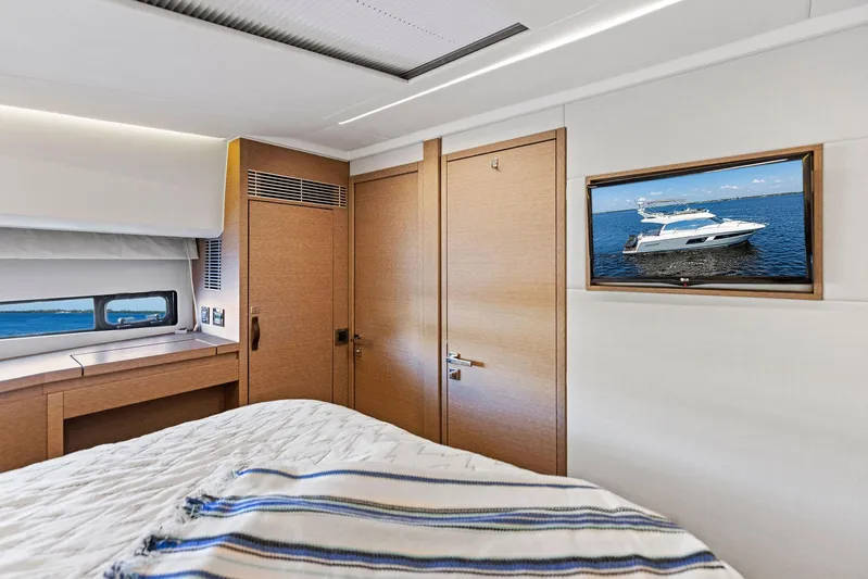  Yacht Photos Pics Luxurious bedroom interior of 2018 Prestige 460 yacht with TV and window view.