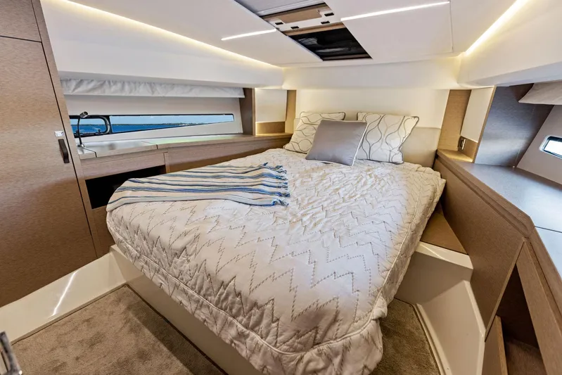  Yacht Photos Pics Luxurious bedroom interior of 2018 Prestige 460 yacht with cozy bedding and modern lighting.