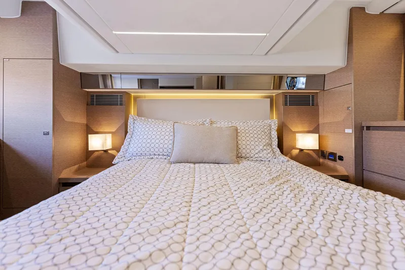  Yacht Photos Pics Luxurious bedroom interior of 2018 Prestige 460 yacht with modern bedding and ambient lighting.