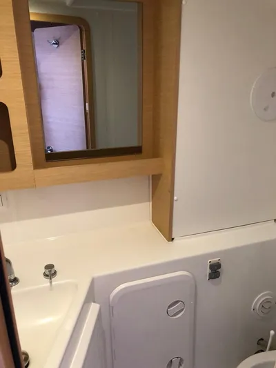 Darwin Yacht Photos Pics Modern bathroom in a 2020 Lagoon 42 catamaran with wooden accents.