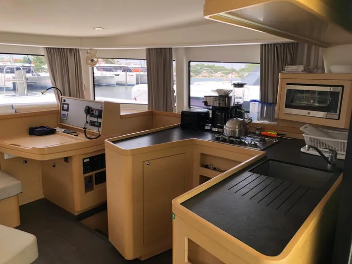 Darwin Yacht Photos Pics Interior of 2020 Lagoon 42 catamaran with modern kitchen and navigation station.