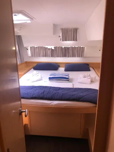 Darwin Yacht Photos Pics 2020 Lagoon 42 catamaran bedroom with cozy bedding and natural light.