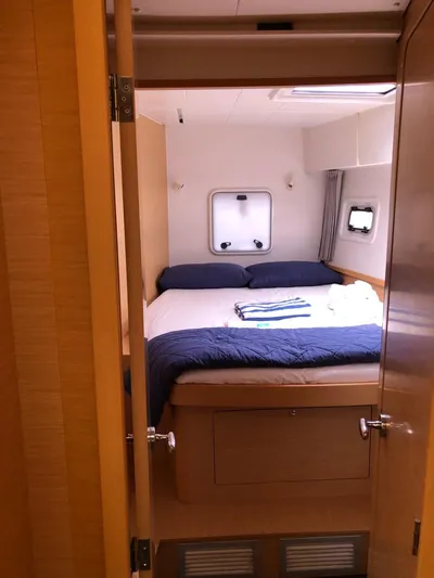 Darwin Yacht Photos Pics Cozy bedroom in 2020 Lagoon 42 catamaran with double bed and porthole windows.