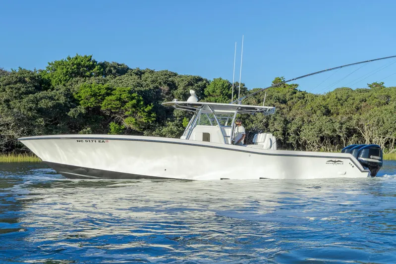  Yacht Photos Pics 2015 Invincible 39 Open Fisherman boat cruising on calm water.