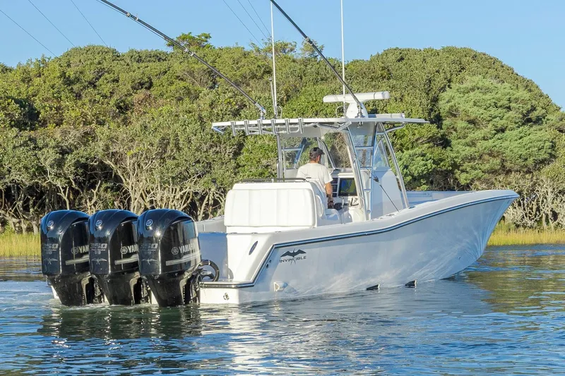  Yacht Photos Pics 2015 Invincible 39 Open Fisherman boat with triple Yamaha engines on calm water.