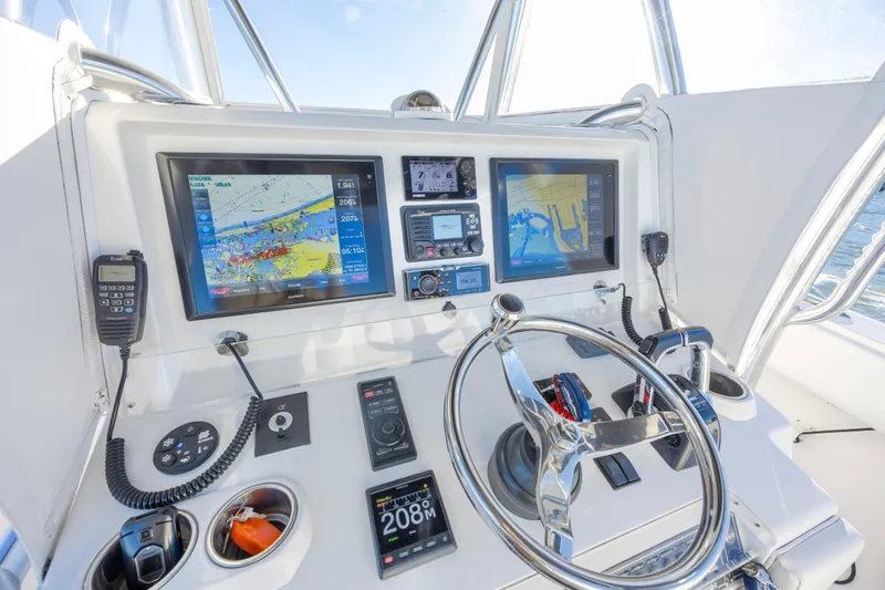  Yacht Photos Pics Control panel of 2015 Invincible 39 Open Fisherman with navigation screens and steering wheel.