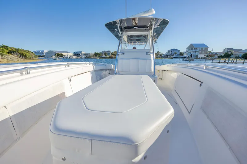  Yacht Photos Pics 2015 Invincible 39 Open Fisherman boat with spacious deck and seating, docked near waterfront homes.