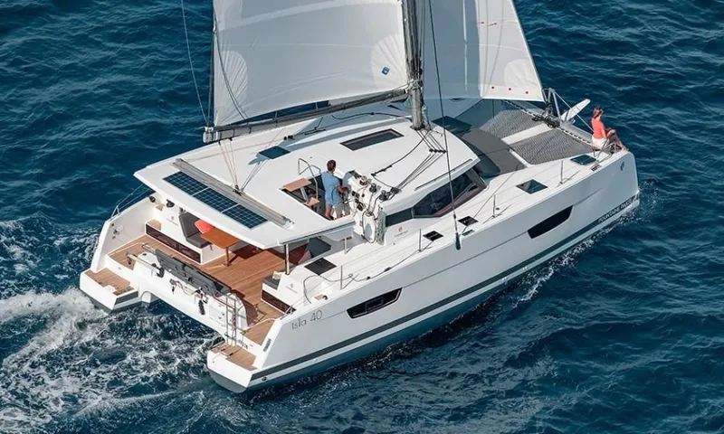  Yacht Photos Pics 2023 Fountaine Pajot Isla 40 catamaran sailing on blue ocean waters.